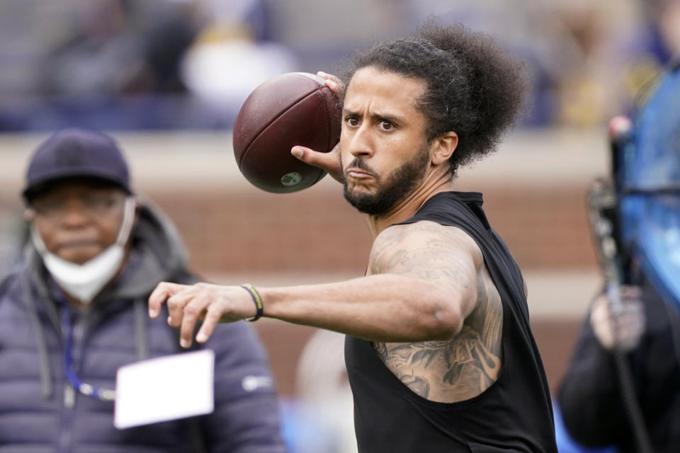 FILE- free agent quarterback Colin Kaepernick throws during halftime of an NCAA college football intrasquad spring game at Michigan, on April 2, 2022, in Ann Arbor, Mich. Kaepernick is getting his first chance to work out for an NFL team since last playing in the league in 2016 when he started kneeling during the national anthem to protest police brutality and racial inequality. Two people familiar with the situation said on Wednesday, May 25, 2022, that Kaepernick will work out for the Las Vegas Raiders. (AP Photo/Carlos Osorio, File)