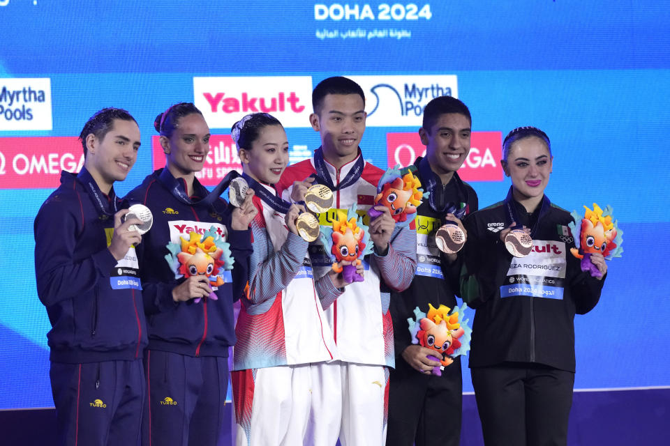 Gold medalists Shi Haoyu and Cheng Wentao, of China, center, silver medalists Dennis Gonzalez Boneu and Mireia Hernandez Luna, of Spain, and bronze medalistsTrinidad Meza Rodriguez and Diego Villalobos Carrillo of Mexico, pose for a photo during the medal ceremony for the mixed duet free final of artistic swimming at the World Aquatics Championships in Doha, Qatar, Saturday, Feb. 10, 2024. (AP Photo/Lee Jin-man)