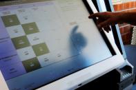 FILE PHOTO: A voter casts a ballot on a new Election Systems & Software ExpressVote XL voting machine in Hanover Township