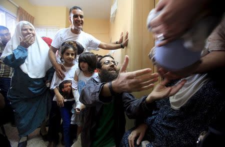 Islamic Jihad leader Khader Adnan is surrounded by his relatives upon his release from an Israeli jail, in the West Bank village of Arabeh near Jenin July 12, 2015. REUTERS/Stringer