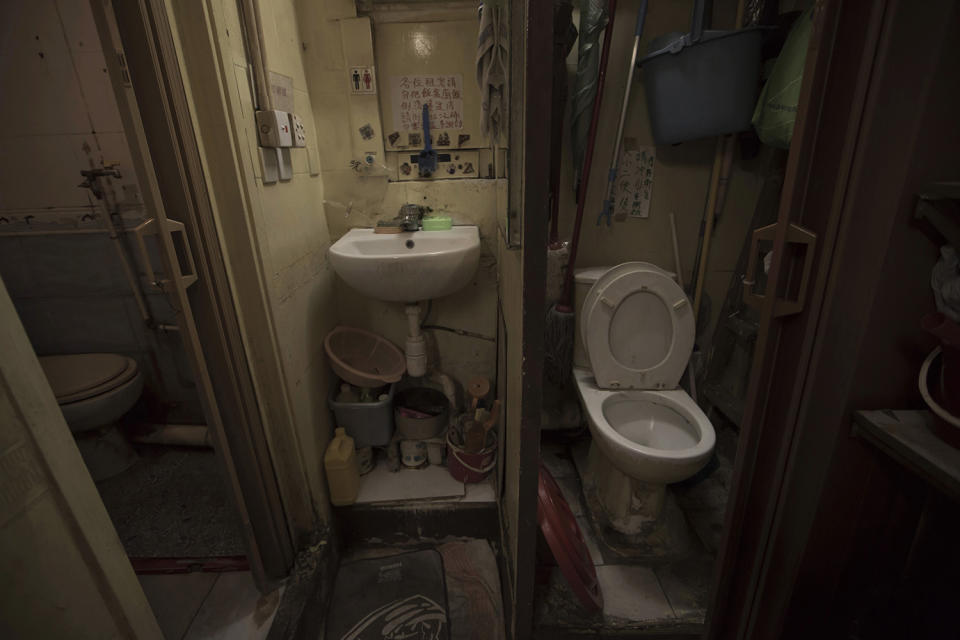 <p>A set of grimy toilets and single sink shared by two dozen inhabitants, including a few single women, are located in an apartment in Hong Kong, March 28, 2017. In wealthy Hong Kong, there’s a dark side to a housing boom, with hundreds of thousands of people forced to live in partitioned shoebox apartments, or “coffin homes,” and other types of inadequate housing. (Photo: Kin Cheung/AP) </p>