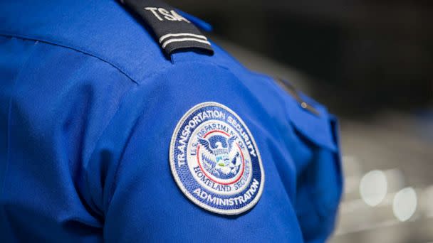 PHOTO: A Transportation Security Administration (TSA) agent's patch is seen as she helps travelers place their bags through the 3-D scanner at the Miami International Airport on May 21, 2019 in Miami. (Joe Raedle/Getty Images, FILE)