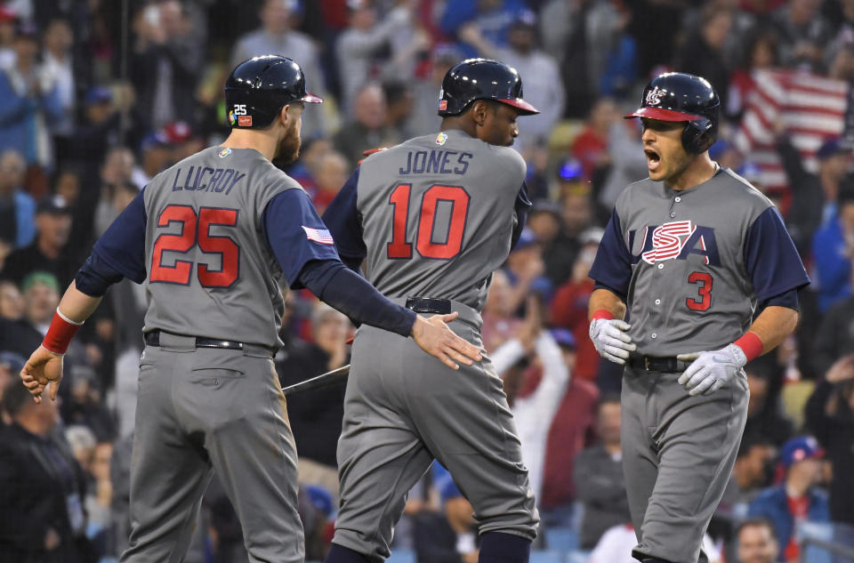 United States' Ian Kinsler, right, celebrates his two-run home run with Jonathan Lucroy, left, and Adam Jones during the third inning against Puerto Rico in the final of the World Baseball Classic in Los Angeles, Wednesday, March 22, 2017. (AP Photo/Mark J. Terrill)