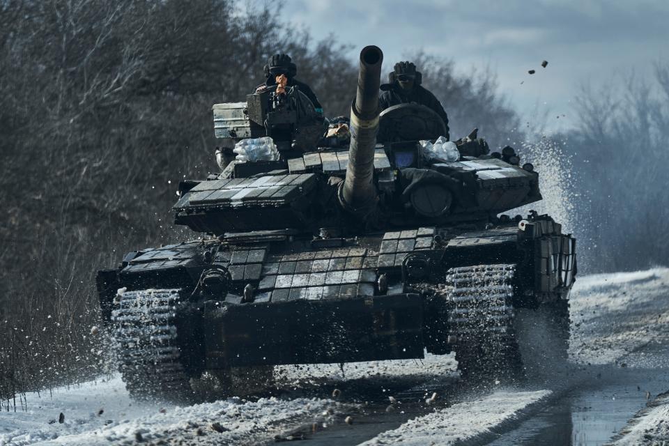 Ukrainian soldiers ride atop a tank in the frontline in Bakhmut, Donetsk region, Ukraine, Monday, Feb. 20, 2023.