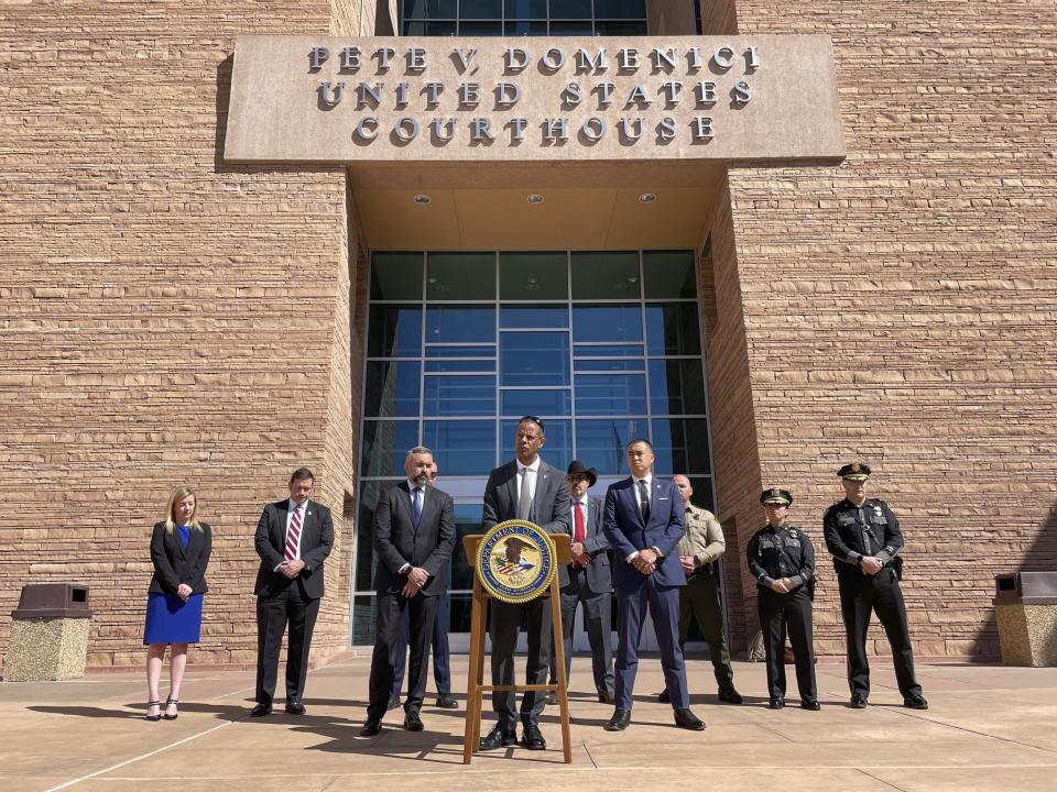 New Mexico Department of Public Safety Secretary Jason Bowie stands at the podium flanked by state and federal officials as charges are announced in the March 15 killing of New Mexico State Police Officer Justin Hare, during a joint news conference in Albuquerque, N.M., on Friday, March 22, 2024. The defendant, Jaremy Smith, made his initial appearance in court on Friday. (AP Photo/Susan Montoya Bryan)