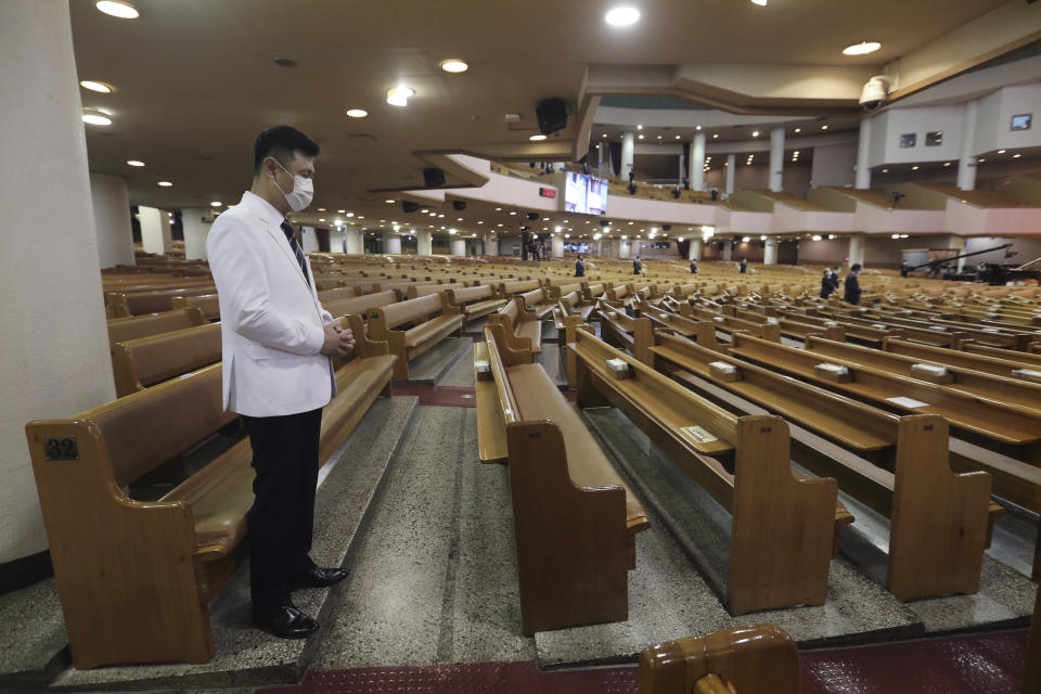 A pastor wearing a face mask to help protect against the spread of the coronavirus prays during a service at the Yoido Full Gospel Church in Seoul, South Korea, Sunday, Sept. 20, 2020. South Korea's new coronavirus tally has fallen below 100 for the first time in more than a month. (AP Photo/Ahn Young-joon)