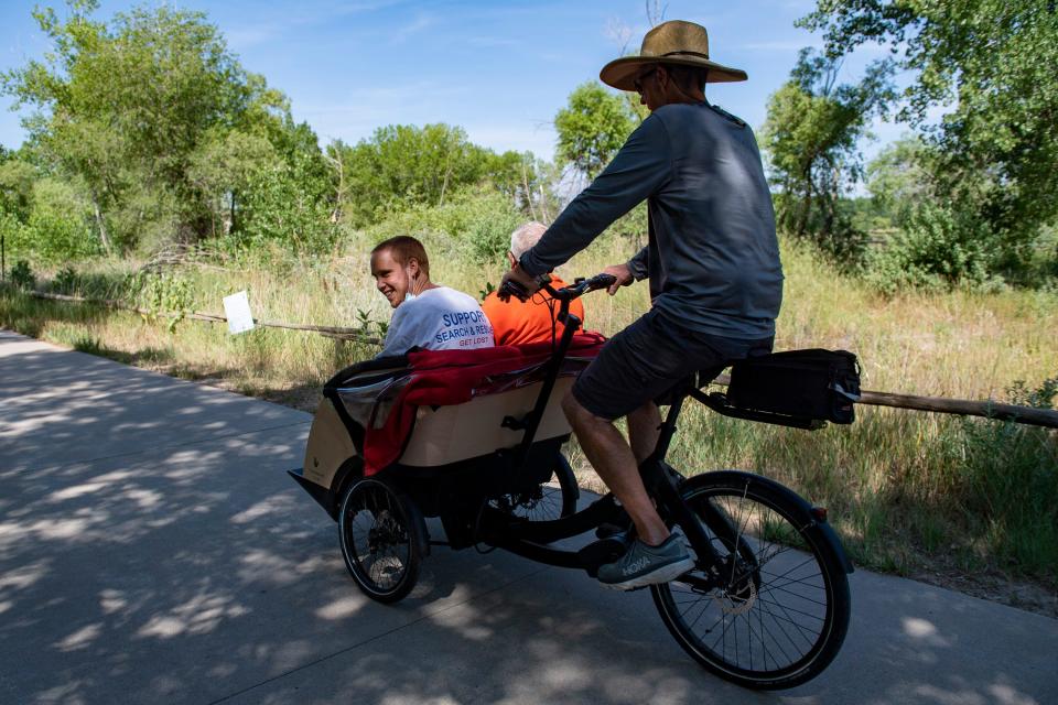 Passengers enjoy a ride along the Poudre River Trail on a trishaw piloted by Keith Williams in Greeley on Thursday, Aug. 4, 2022.