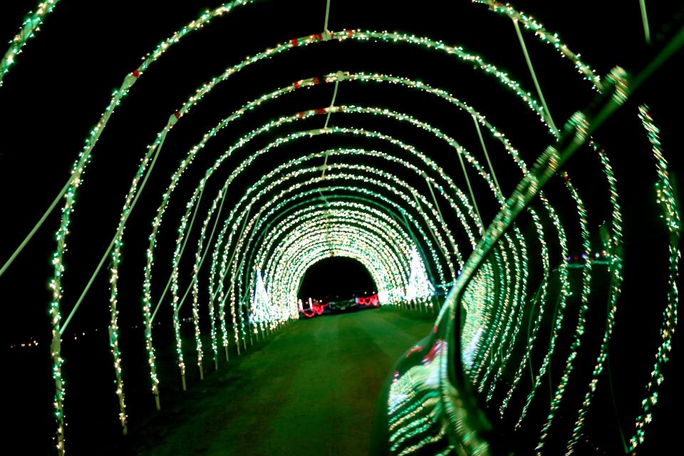 A car goes through a tunnel of lights at Santa's Rock N Lights Show on Dec. 2, 2020, at the Brown County Fairgrounds in De Pere. A similar drive-thru holiday lights display, Holiday Lights on the Fox, is being held at the fairgrounds this year.