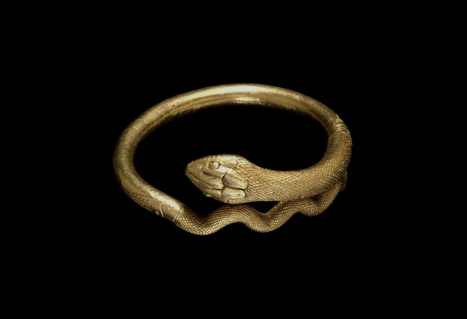 Undated handout photo issued by the British Musuem Thursday Sept. 20, 2012 of a gold bracelet in the form of a coiled snake, 1st Century AD, Roman, Italy as dozens of objects recovered from the ruins of Roman cities Pompeii and Herculaneum will go on show outside Italy for the first time at a new exhibition at the museum. The two cities on the Bay of Naples were wiped out by the eruption of Mount Vesuvius in 79 AD. The show will feature objects found in their ruins including jewellery, carbonised food and a baby’s crib that still rocks on its curved runners. The exhibition will run March 28 to Sept. 29, 2013. (AP Photo/The Trustees of the British Museum)