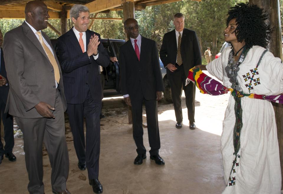 U.S. Secretary of State John Kerry, second left, applauds a local dancer prior to speaking prior to speaking about U.S. policy in Africa at the Gullele Botanic Garden in Addis Ababa, Ethiopia Saturday, May 3, 2014. America's top diplomat said the U.S. is ready to help increase its ties with Africa, but nations across the continent need to take stronger steps to ensure security and democracy for its people. (AP Photo/Saul Loeb, Pool)