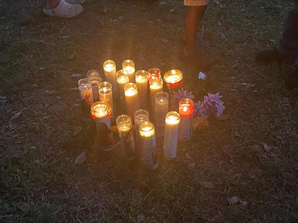 A candlelight vigil held at the spot where neighbors said Ajike Shantrell "AJ" Owens fell after she was reportedly shot by another neighbor on Friday night.