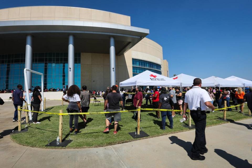 Parents wait in a long line to pick up their children at Mansfield school district’s Center for Performing Arts after a shooting at Timberview High School Wednesday, Oct. 6, 2021, in Mansfield.