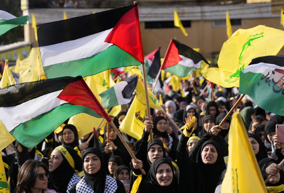 Supporters of the Iranian-backed Hezbollah group shout slogans and wave Palestinian and their group flags, as they wait the speech of Hezbollah leader Sayyed Hassan Nasrallah, during a rally to commemorate Hezbollah fighters who were killed in South Lebanon last few weeks while fighting against the Israeli forces, in Beirut, Lebanon, Friday, Nov. 3, 2023. Nasrallah's speech had been widely anticipated throughout the region as a sign of whether the Israel-Hamas conflict would spiral into a regional war. (AP Photo/Hussein Malla)