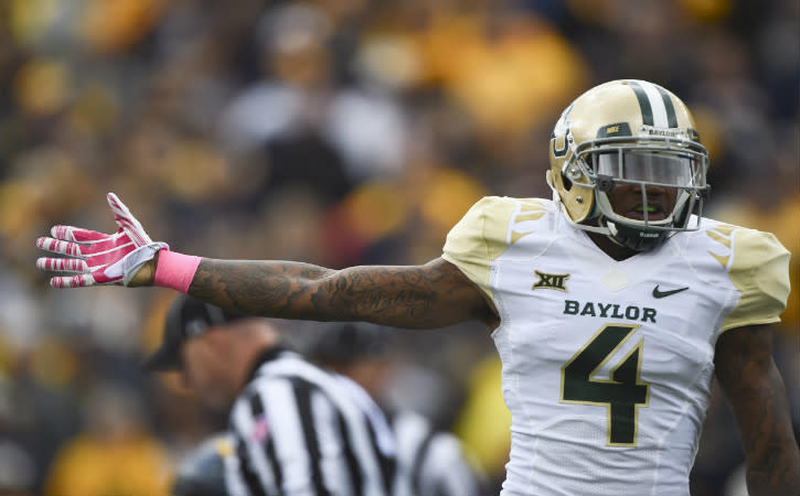 Oct 18, 2014; Morgantown, WV, USA; Baylor Bears cornerback Xavien Howard (4) signals they had recovered the fumble during the first quarter against the West Virginia Mountaineers at Milan Puskar Stadium. Mandatory Credit: Tommy Gilligan-USA TODAY Sports