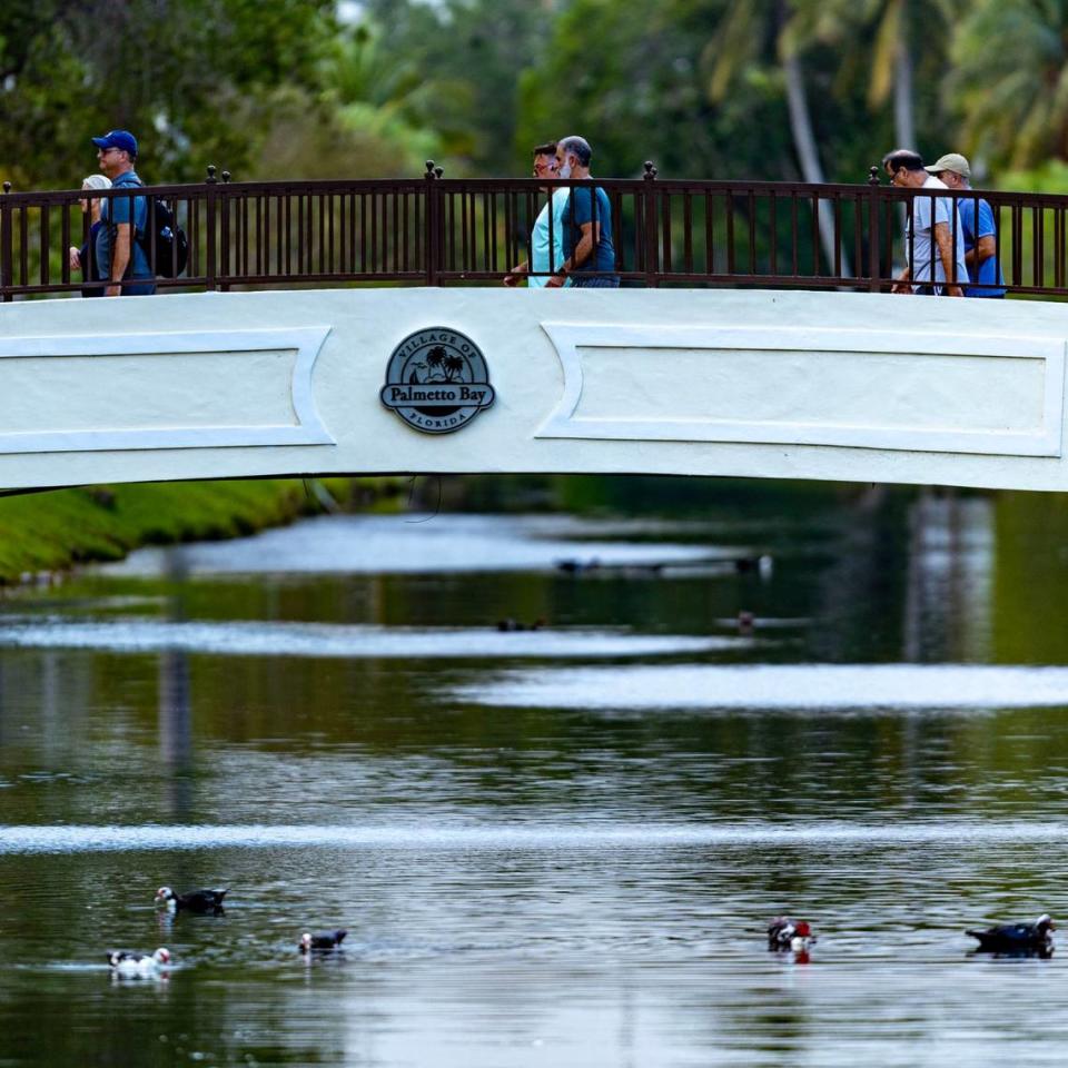 People cross a bridge at Coral Reef Park in Palmetto Bay, Florida, on Thursday, April 13, 2023.