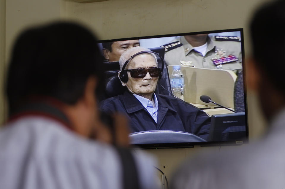 Nuon Chea, who was the Khmer Rouge's chief ideologist and No. 2 leader, is seen on screen at the court's press center at the U.N.-backed war crimes tribunal on the outskirts of Phnom Penh, Cambodia, Friday, Nov. 16, 2018. The U.N.-backed tribunal judging the criminal responsibility of former Khmer Rouge leaders for the deaths of an estimated 1.7 million Cambodians will issue verdicts Friday in the latest — and perhaps last — of such trials. (AP Photo/Heng Sinith)