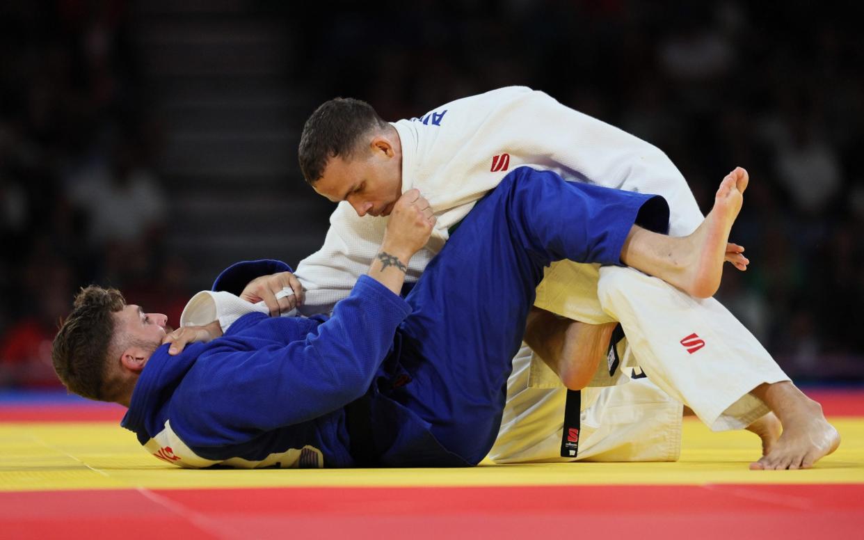 Arthur Cavalcante da Silva of Brazil (white) and GB's Daniel Powell (blue) compete during the para judo men's -90kg J1 final