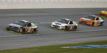 Aric Almirola (10) leads the way to the finish line to win the 1000Bulbs.com 500 NASCAR Cup Series auto race at Talladega Superspeedway, Sunday, Oct. 14, 2018, in Talladega, Ala. (AP Photo/Butch Dill)