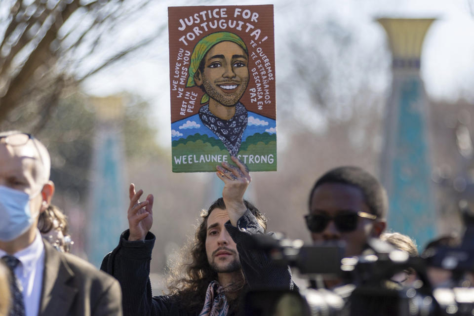 FILE - Noah Gringi holds a sign at a news conference for Manuel Esteban Paez Terán in Decatur, Ga., Monday, Feb. 6, 2023. A prosecutor says on Friday, Oct. 6, no charges will be sought against Georgia state troopers who shot and killed an activist at the site of a planned police and firefighter training center near Atlanta. (Arvin Temkar/Atlanta Journal-Constitution via AP, File)