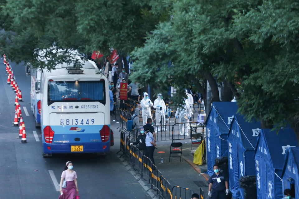 Buses to relocate residents of a neighbourhood to Zhangjiakou in Hebei province for centralised quarantine are seen outside the compound in Haidian district, amid the coronavirus disease (COVID-19) outbreak in Beijing, China May 23, 2022. Picture taken May 23, 2022. China Daily via REUTERS  ATTENTION EDITORS - THIS IMAGE WAS PROVIDED BY A THIRD PARTY. CHINA OUT.