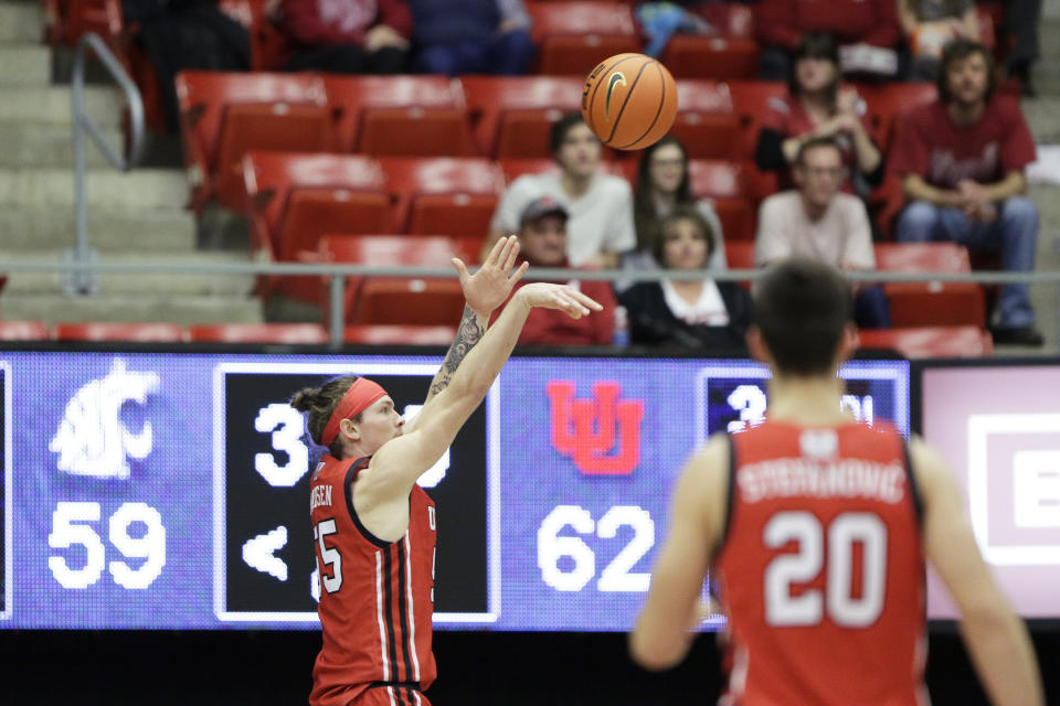 Utah guard Gabe Madsen, left, shoots during overtime of an NCAA college basketball game against Washington State, Sunday, Dec. 4, 2022, in Pullman, Wash. Utah won 67-65. (AP Photo/Young Kwak)