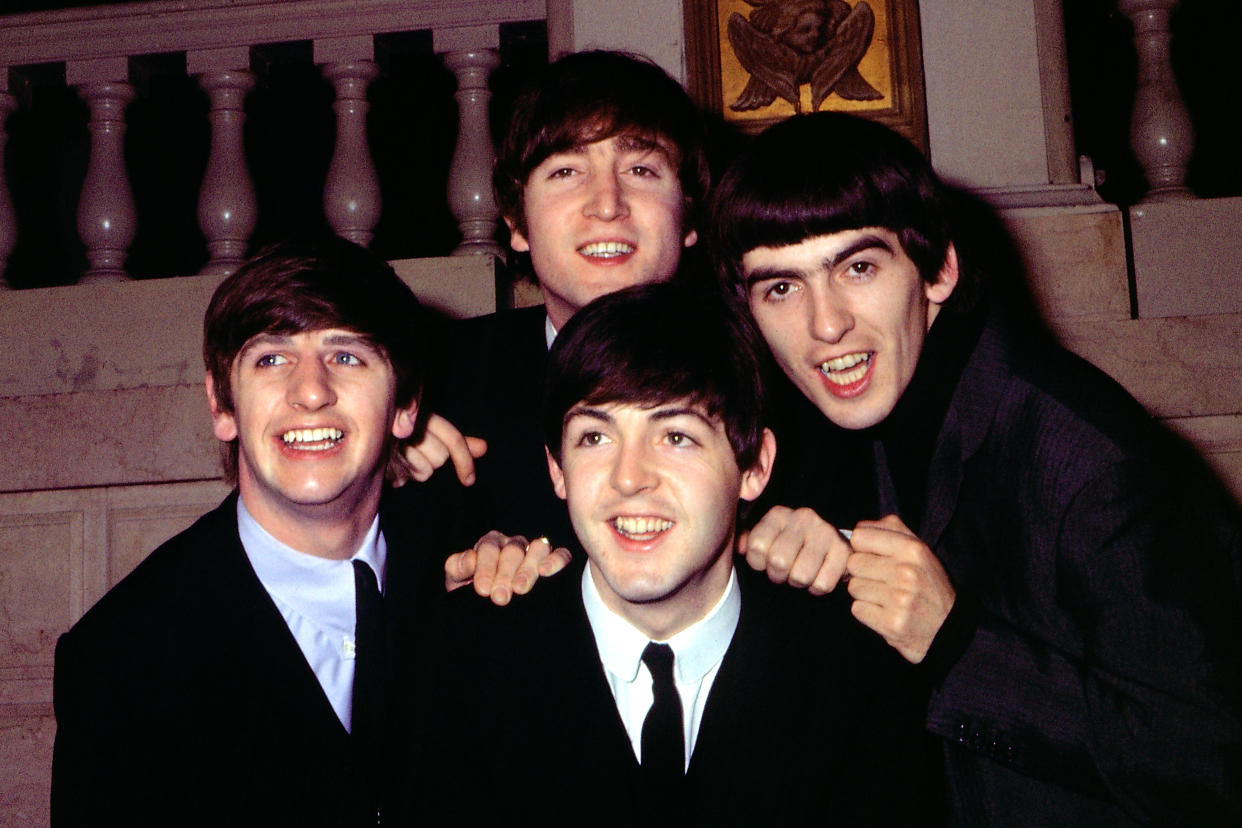 The Beatles pose for a portrait wearing suits in circa 1964