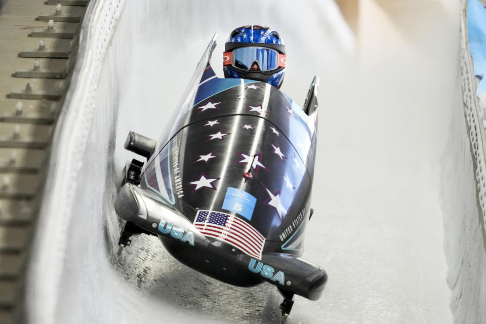 FILE - Kaillie Humphries, of the United States, drives during the women's monobob heat 3 at the 2022 Winter Olympics, Monday, Feb. 14, 2022, in the Yanqing district of Beijing. Three-time Olympic gold medalist Kaillie Humphries of the U.S. announced Monday, Dec. 4, 2023, that she is missing this season because she and her husband are expecting their first child, due in June. ( (AP Photo/Dmitri Lovetsky, File)