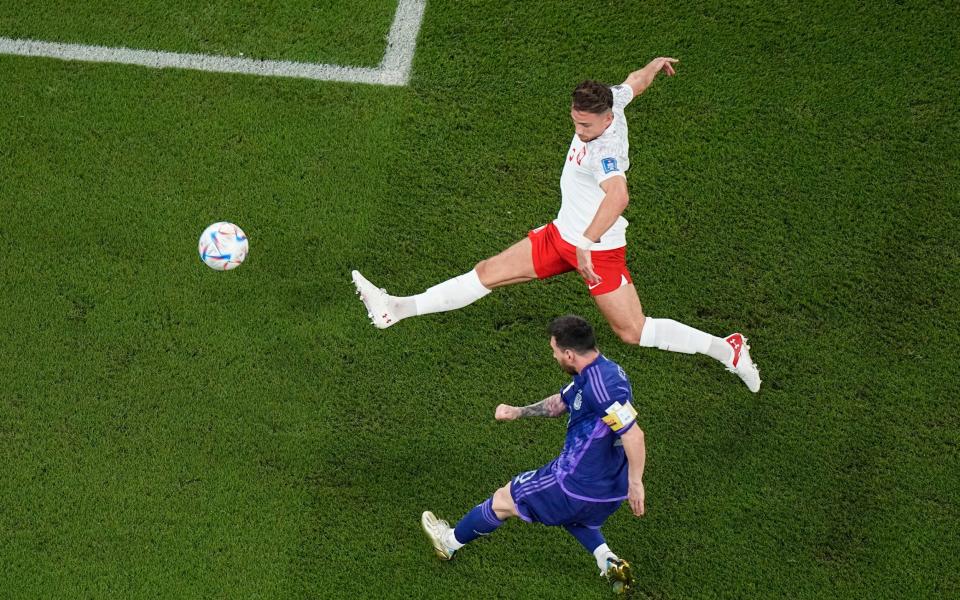 Argentina's Lionel Messi tries to score in front of Poland's Matty Cash - AP