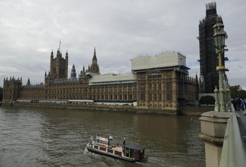 Climate protestors on a boat with a banner reading "Tell the Truth" passes Britain's Parliament in central London Monday, Oct. 7, 2019. Activists with the Extinction Rebellion movement blocked major roads in London, Berlin and Amsterdam on Monday at the beginning of what was billed as a wide-ranging series of protests demanding new climate policies. (AP Photo/Matt Dunham)