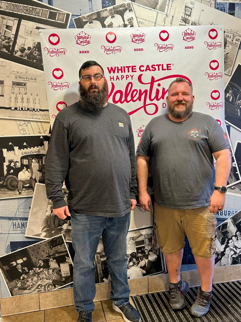 Justin Gilliam, left, and Kevin Pyles pose in front of a White Castle Valentine's Day backdrop Feb. 14, 2023, at the South Nashville store