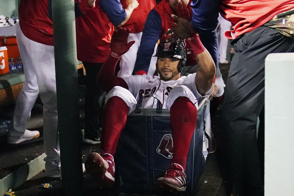 Boston Red Sox's Tommy Pham is congratulated after his three-run home run against the Atlanta Braves during the seventh inning of a baseball game Wednesday, Aug. 10, 2022, in Boston. (AP Photo/Charles Krupa)