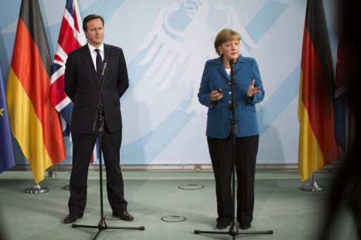 German Chancellor Angela Merkel and British Prime Minister David Cameron address a press conference at the chancellery in Berlin. Merkel pushed for a stronger European political union Thursday amid growing international calls for action as a brutal Spain ratings downgrade added another twist to the eurozone crisis