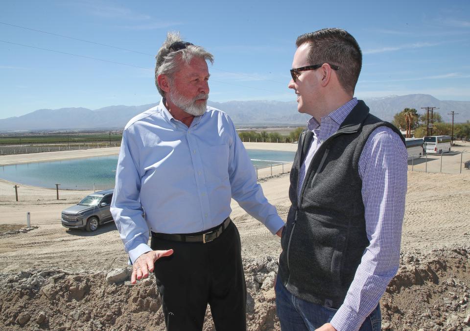 JB Hamby, right, chairman of the Colorado River Board speaks with Jim Barrett of the Coachella Valley Water District in an agricultural area of Thermal, Calif., March 8, 2023. 
