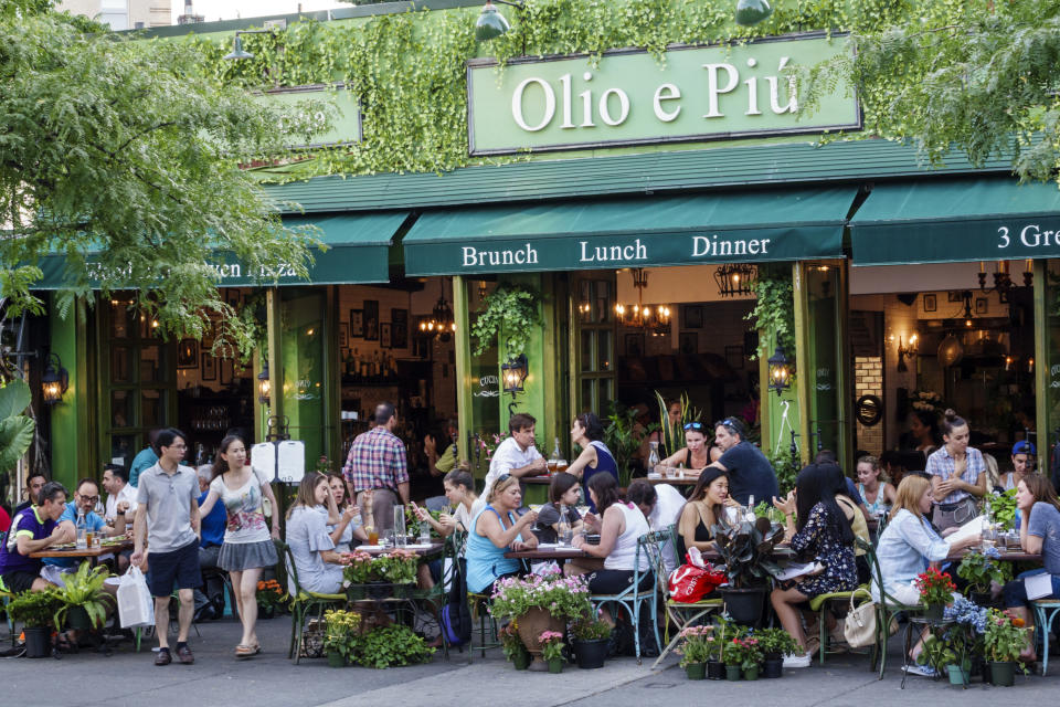 people eating outside of a restaurant