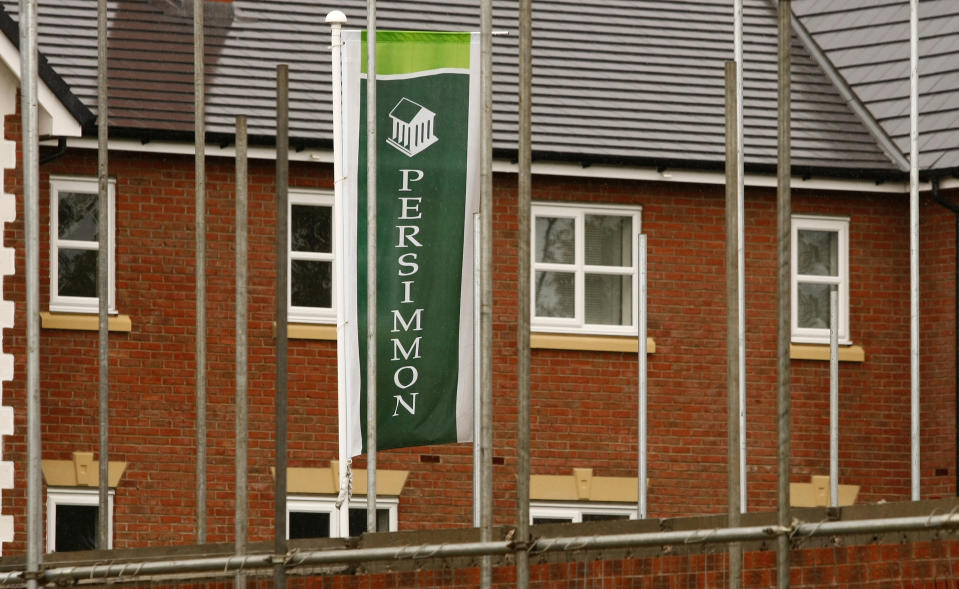 A Persimmon banner flies at a new housing development near Manchester, northern England, July 7, 2008. British media reported on Monday that House builder Persimmon will confirm on Tuesday that it has made around 1,000 staff redundant. REUTERS/Phil Noble (BRITAIN)