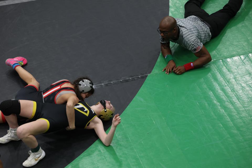 Bri Graves, top, of Oak Hills, wrestling in the finals of the 100 lb weight class, competes against Vita Savage, of Taylor High School. Graves won by pin in the first period of the OHSAA regional girls wrestling tournament at Harrison High School March 5, 2023. The top four girls in each weight class advance to the state tournament in Columbus, Ohio.