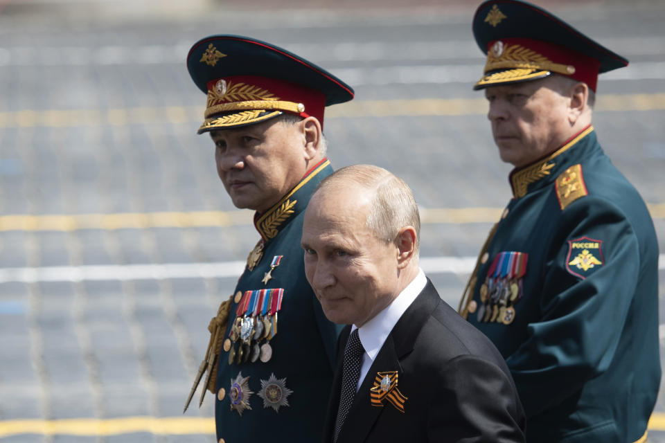 Russian President Vladimir Putin, center, and, Defense Minister Sergei Shoigu, left, leave Red Square after the Victory Day military parade marking the 75th anniversary of the Nazi defeat in Moscow, Russia, Wednesday, June 24, 2020. Russian President Vladimir Putin hailed the defeat of Nazi Germany at the traditional massive Red Square military parade, which was delayed by more than a month because of the invisible enemy of the coronavirus. The parade is usually held May 9 on Victory Day, Russia's most important secular holiday but was postponed until Wednesday due to the pandemic. (AP Photo/Pavel Golovkin, Pool)