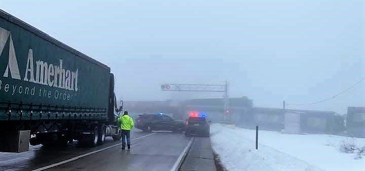 Officials work at a scene following a crash between a train and dump trucks on U.S. 141 north of Pound on Dec. 15.