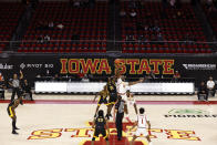 Arkansas-Pine Bluff forward Alvin Stredic and Iowa State forward Solomon Young leap for the tip-off during the first half of an NCAA college basketball game with few people in the stands, Sunday, Nov. 29, 2020, in Ames, Iowa. (AP Photo/Matthew Putney)