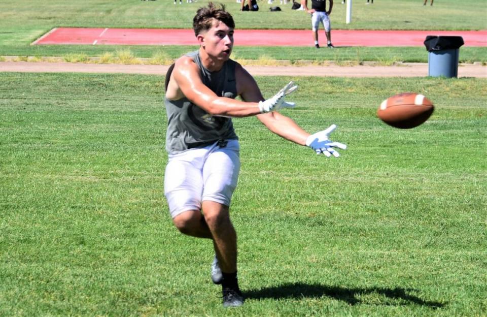 Buhach Colony High School senior Marcellos Avalos tries to bring in a pass during practice on Tuesday, Aug. 15, 2023 in Atwater, Calif.