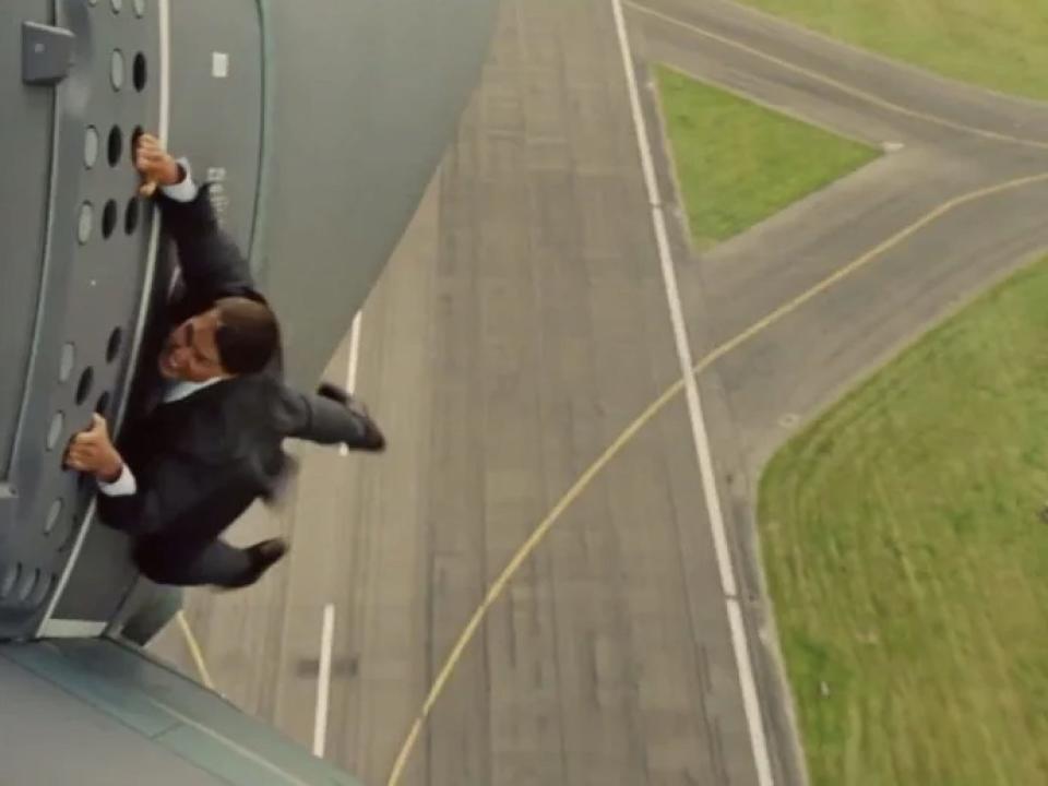 Tom Cruise hanging on to the side of a plane in "Mission: Impossible - Rogue Nation."