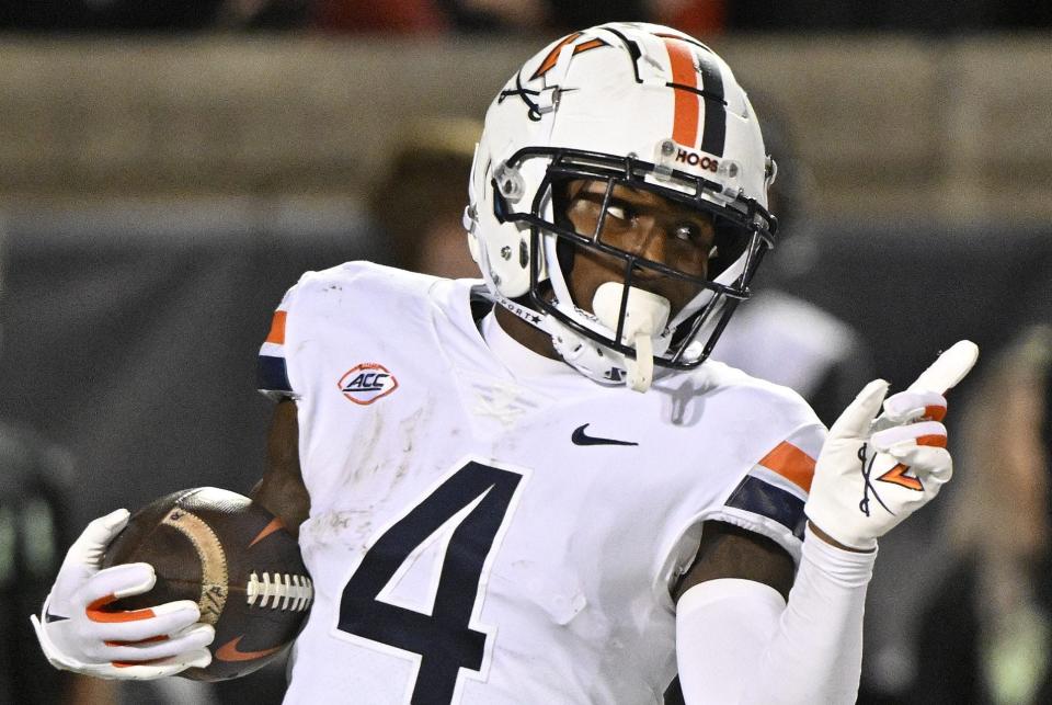 Nov 9, 2023; Louisville, Kentucky, USA; Virginia Cavaliers wide receiver Malik Washington (4) celebrates after scoring a touchdown against the Louisville Cardinals during the second half at L&N Federal Credit Union Stadium. Louisville defeated Virginia 31-24. Mandatory Credit: Jamie Rhodes-USA TODAY Sports