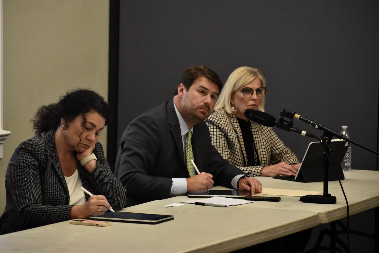 Commissioners of the Kentucky Public Service Commission take notes during public comment on an LG&E and KU plan to retire coal-fired generation units and replace them with natural gas and renewables. From left: Vice Chair Angie Hatton, Chairman Kent Chandler and Commissioner Mary Pat Regan. Aug. 16, 2023