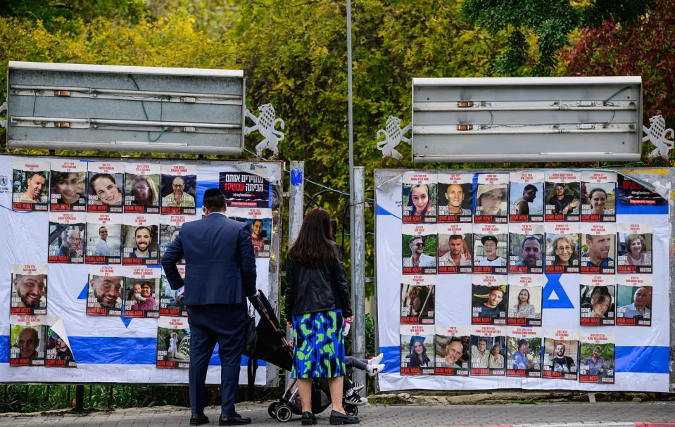 People look at billboards. (John MacDougal / AFP via Getty Images)