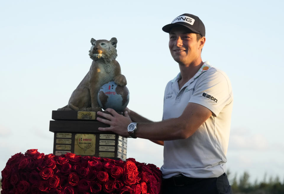 Norway,'s Viktor Hovland, right, holds the trophy after winning the Hero World Challenge PGA Tour at the Albany Golf Club in New Providence, Bahamas, Sunday, Dec. 4, 2022. (AP Photo/Fernando Llano)