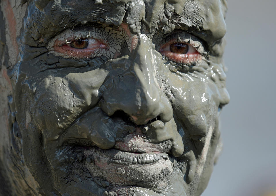 <p>A participant smiles after his handball match at the so called “Wattoluempiade” (Mud Olympics) in Brunsbuettel at the North Sea, Germany July 30, 2016. (REUTERS/Fabian Bimmer) </p>