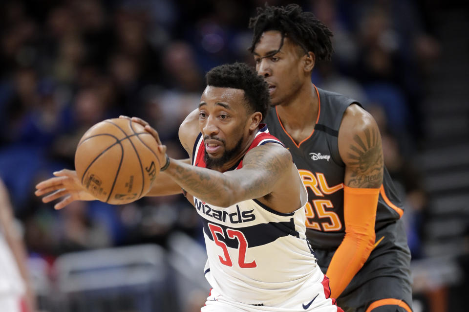 Washington Wizards guard Jordan McRae (52) is fouled by Orlando Magic forward Wes Iwundu, right, as he tries to moves the ball on a fast break during the first half of an NBA basketball game Wednesday, Jan. 8, 2020, in Orlando, Fla. (AP Photo/John Raoux)