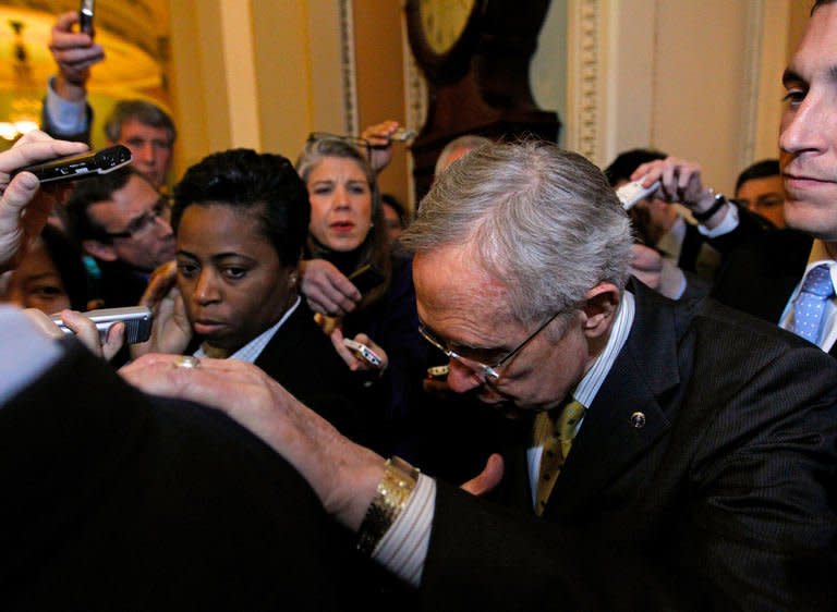 Senate Majority Leader Harry Reid is surrounded by reporters as he walks out of the Mansfield Room after a caucus meeting in the US Capitol on December 30, 2012, in Washington. Despite rising hopes, the economy will technically go over the cliff at midnight after the aides to Republican leaders in the House of Representatives said no vote on a pact could be scheduled before Tuesday