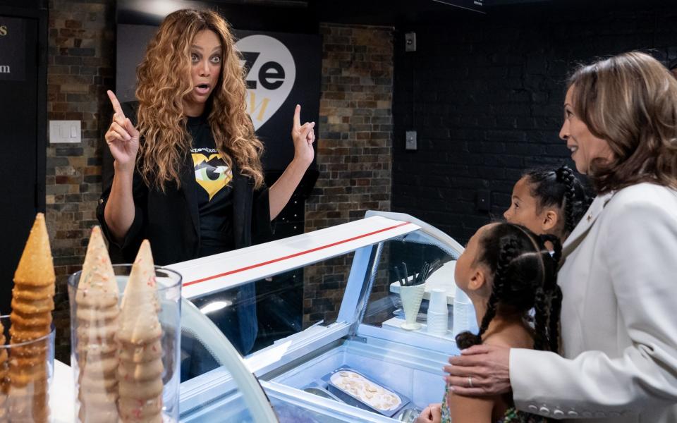 WASHINGTON, DC - JULY 19: Vice President Kamala Harris and her two grand nieces order from Tyra Banks at her new shop, Smize Dream Ice Cream, on July 19, 2024 in Washington, DC. Harris made the stop as pressure continues to increase on President Joe Biden to end his presidential campaign. (Photo by Nathan Howard/Getty Images)