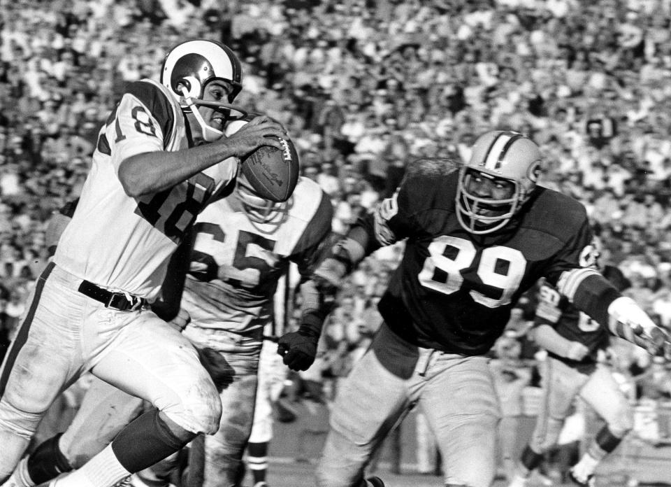 Los Angeles Rams quarterback Roman Gabriel (18) is chased by Packers linebacker Dave Robinson (89) during the Rams 27-24 victory over the Green Bay Packers on December 9, 1967 at the Los Angeles Memorial Coliseum in Los Angeles, California.   (AP Photo/NFL Photos)